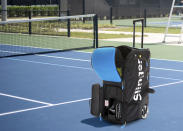 This image provided by Slinger shows a tennis ball launcher bag. Tennis nuts can tote Slinger's portable tennis ball launcher to the court; the bag holds 144 balls, and the five-hour battery means dad can practice his strokes as long as he wants. (Slinger via AP)