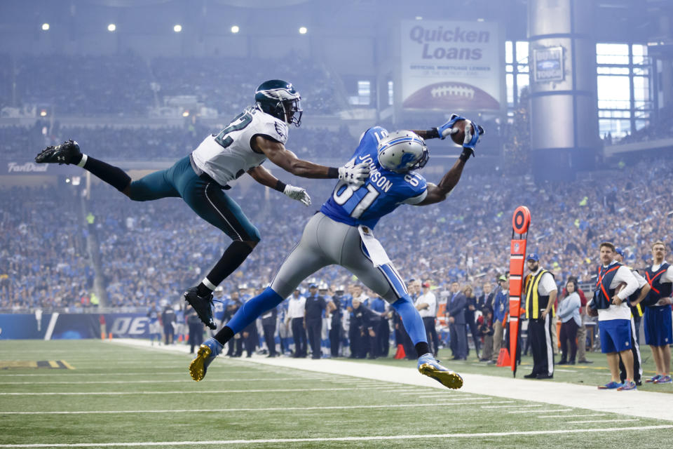 FILE - In this Nov. 26, 2015, file photo, Detroit Lions wide receiver Calvin Johnson (81), defended by Philadelphia Eagles cornerback Eric Rowe (32) , catches a pass for a touchdown during the second half of an NFL football game, in Detroit. Calvin Johnson is simply in awe that he will soon join Jim Brown and Gale Sayers as Pro Football Hall of Famers inducted at the age of 35 years old or younger. (AP Photo/Rick Osentoski, File)