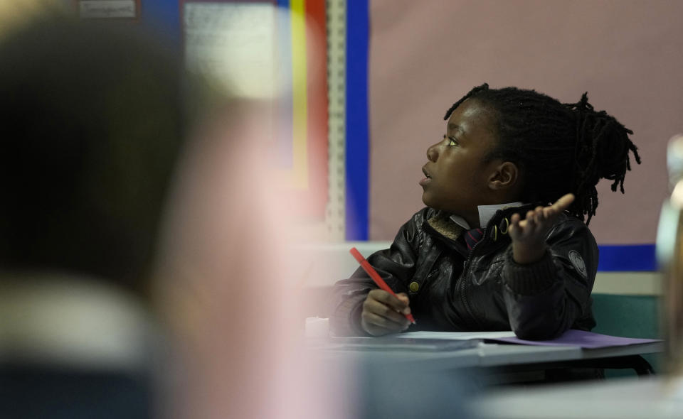 Elijah gestures as she takes part in a maths lesson in year 3 at the Holy Family Catholic Primary School in Greenwich, London, Thursday, May 20, 2021. (AP Photo/Alastair Grant)