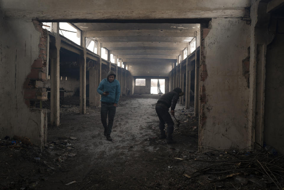 Migrants gather near the Hungarian border, outside of the village of Majdan, Serbia, Tuesday, Jan. 11, 2022. Hungary's nationalist prime minister, Viktor Orban, is keen to use the threat of migrants at his country's southern border to give him an advantage in upcoming elections. But the scale of migration pressure claimed by Orban is drawn into question by statistics from neighboring Serbia and the European Union's border agency. (AP Photo/Bela Szandelszky)