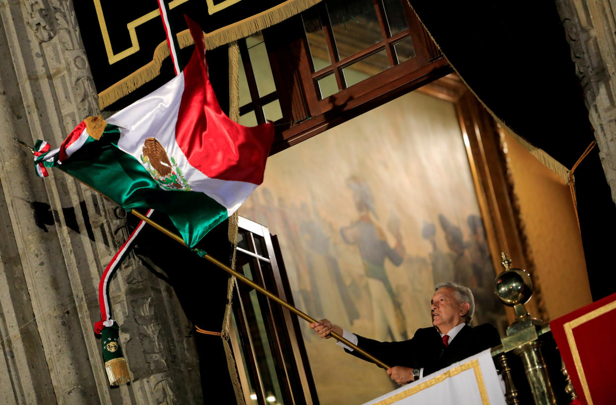 Mexico's President Andres Manuel Lopez Obrador waves the national flag as Mexico marks the 209th anniversary of its independence from Spain at the National Palace in Mexico City, Mexico, September 15, 2019. REUTERS/Carlos Jasso     TPX IMAGES OF THE DAY