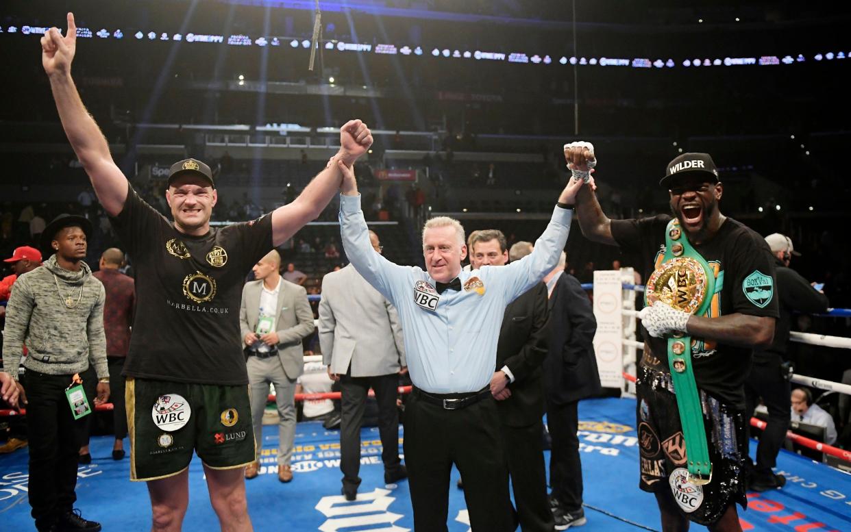 Tyson Fury, left, of England, poses with Deontay Wilder, right, along with referee Jack Reiss after their WBC heavyweight championship boxing match ended in a draw, Saturday, Dec. 1, 2018, in Los Angeles - AP