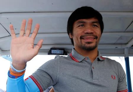 Filipino boxer and Senatorial candidate Manny Pacquiao, waves from a truck during election campaigning in Malabon Metro Manila in the Philippines May 6, 2016. REUTERS/Erik De Castro