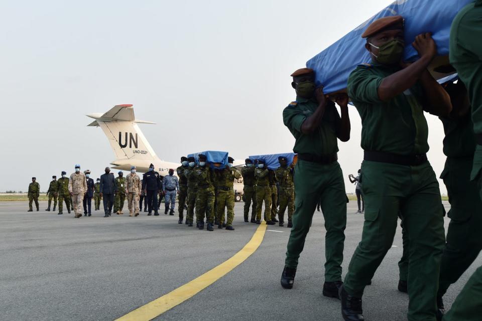 Ivorian soldiers carry the coffins of four U.N. peacekeepers in Mali in February 2021. <a href="https://media.gettyimages.com/photos/ivorian-soldiers-carry-coffins-wrapped-with-united-nations-flags-out-picture-id1230731222?s=2048x2048" rel="nofollow noopener" target="_blank" data-ylk="slk:Sia Kambou/AFP via Getty Images;elm:context_link;itc:0;sec:content-canvas" class="link ">Sia Kambou/AFP via Getty Images</a>