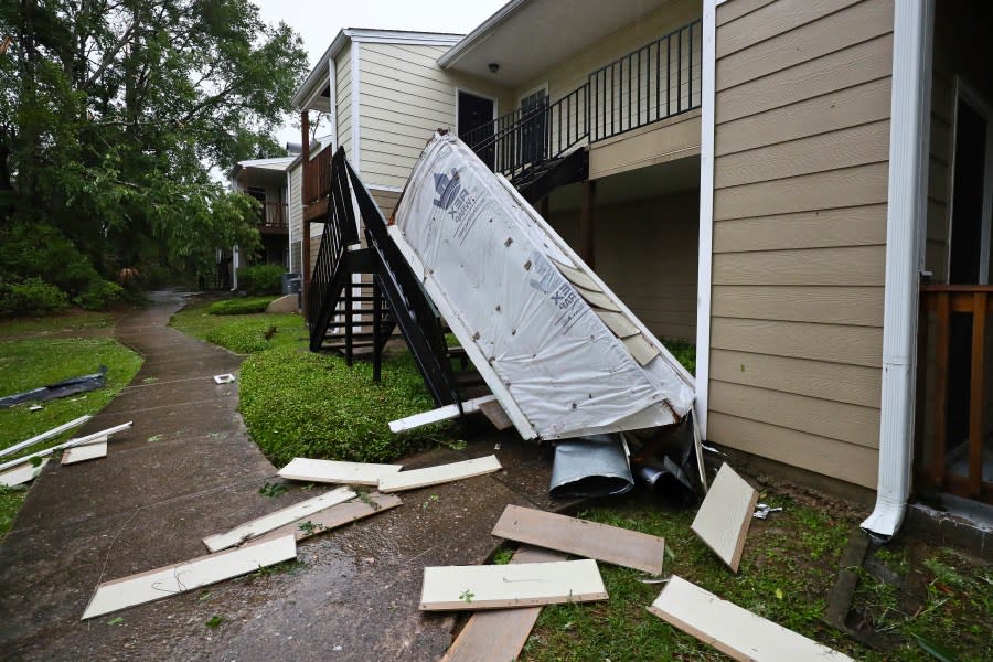 A chimney and siding, blown off a roof by extreme winds, rests in a stairwell at an apartment complex in Tallahassee, Fla., Friday, May 10, 2024. Powerful storms with damaging high winds threatened several states in the Southeast early Friday. (AP Photo/Phil Sears)