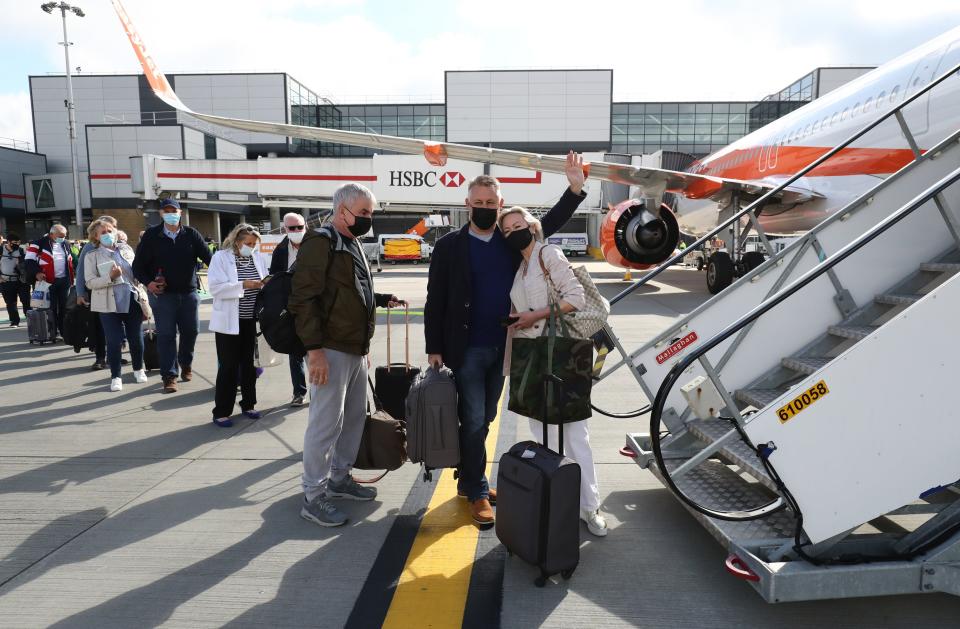 Passengers prepare to board an easyJet flight to Faro, Portugal, at Gatwick Airport (PA)