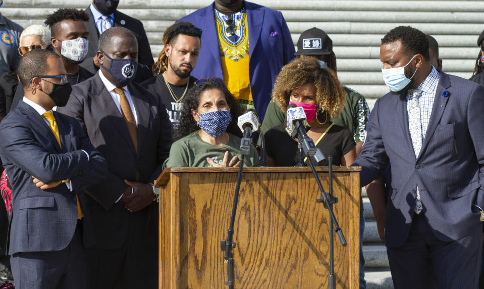 Mona Hardin, center left at podium, mother of Ronald Greene, speaks at a news conference outside the Louisiana State Capitol in Baton Rouge, La., Wednesday, Oct. 7, 2020. Greene died following a police chase in Louisiana in 2019, and his death is now under federal investigation. Greene's family filed a federal wrongful-death lawsuit in May alleging troopers "brutalized" Greene, used a stun gun on him three times and "left him beaten, bloodied and in cardiac arrest," before covering up his actual cause of death. (AP Photo/Dorthy Ray)