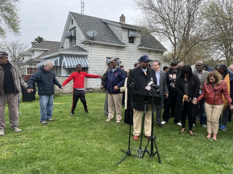 South Bend Common Council member Canneth Lee, a minister, leads a group prayer at a press conference April 21 in reaction to the April 20 shooting death of 11-year-old South Bend resident T'yon Horston.