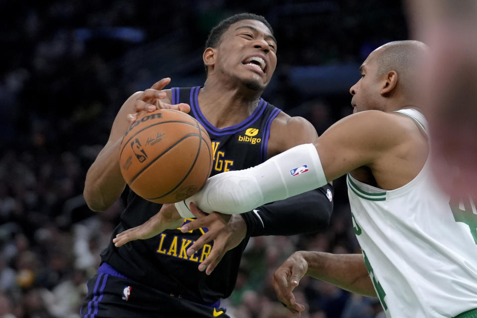 Los Angeles Lakers forward Rui Hachimura, left, and Boston Celtics center Al Horford vie for a loose ball in the second half of an NBA basketball game, Thursday, Feb. 1, 2024, in Boston. (AP Photo/Steven Senne)