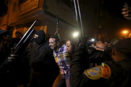 Security forces detain a man at the scene of a bomb blast in a main street in Giza, Egypt, January 21, 2016. REUTERS/Mohamed Abd El Ghany