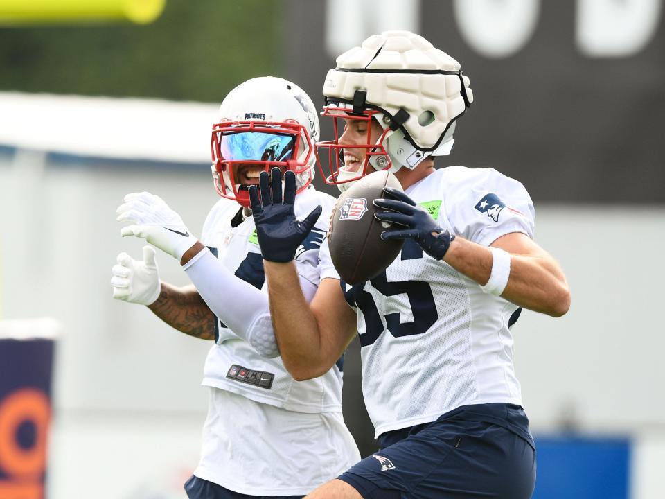 Patriots tight end Hunter Henry, right, and wide receiver Kendrick Bourne react after a drill during training camp last week.