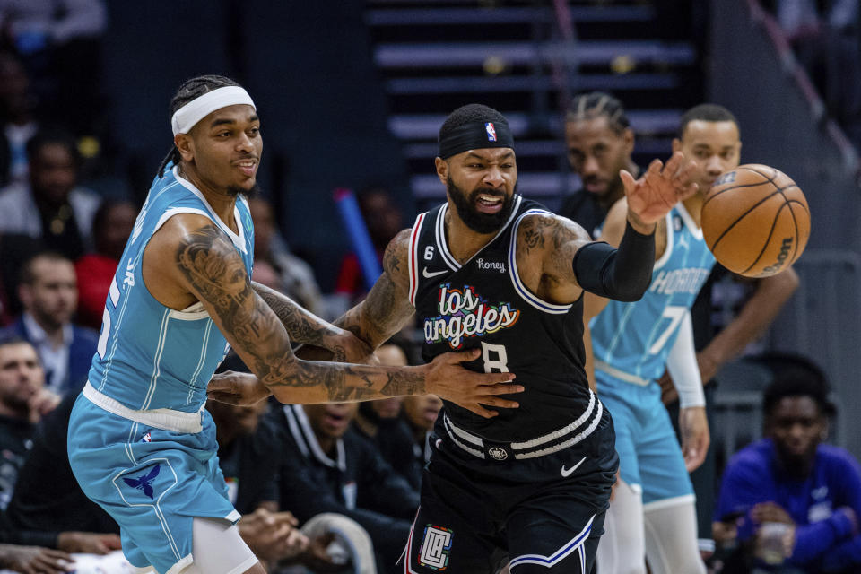 LA Clippers forward Marcus Morris Sr. (8) knocks the ball away from Charlotte Hornets forward P.J. Washington during the first half of an NBA basketball game on Monday, Dec. 5, 2022, in Charlotte, N.C. (AP Photo/Scott Kinser)