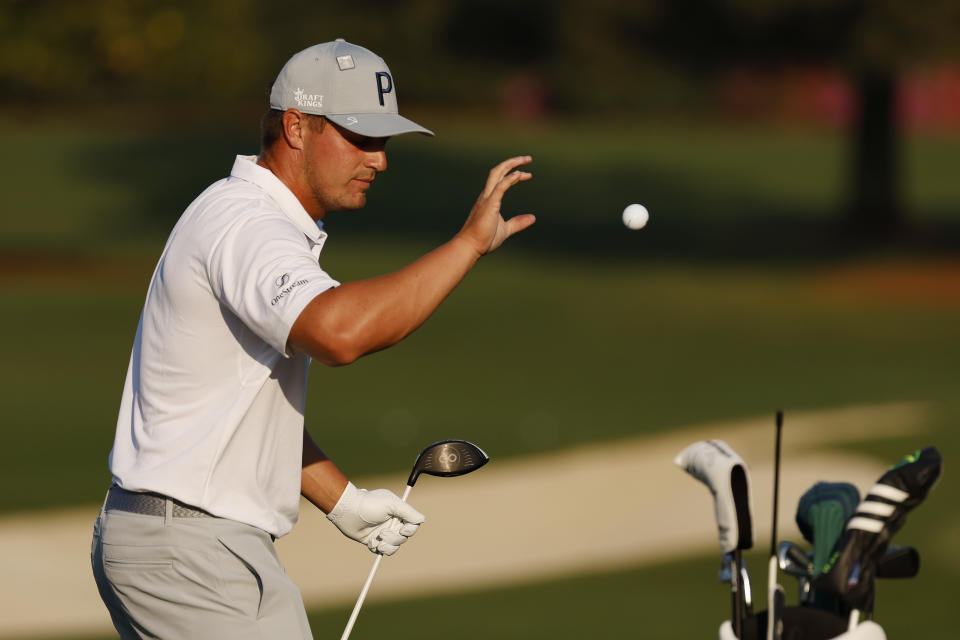 Bryson DeChambeau (pictured) catches a ball as he works on the range during a practice round.