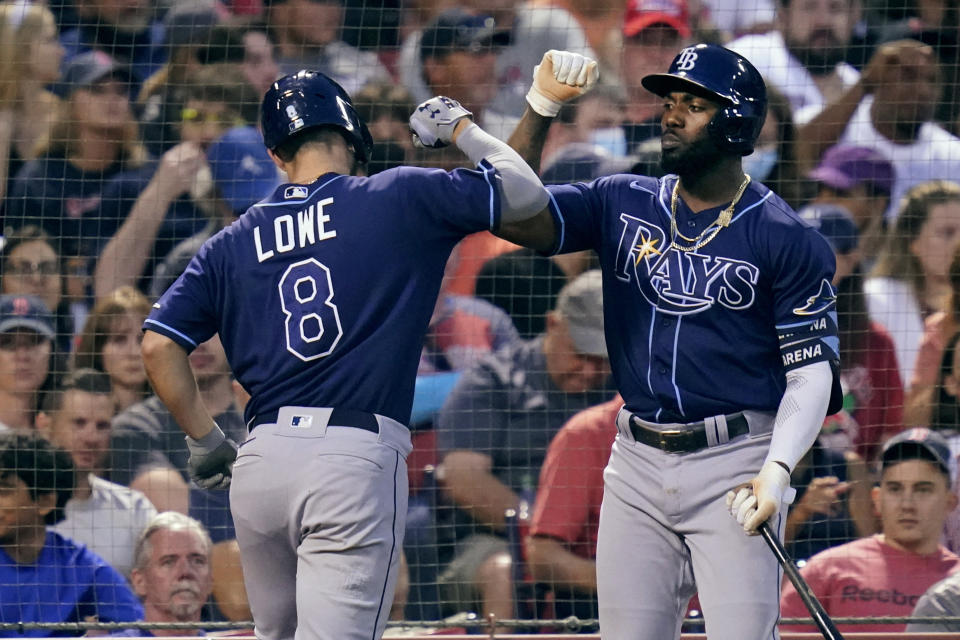 Tampa Bay Rays' Brandon Lowe (8) is congratulated by Randy Arozarena after his solo home run off Boston Red Sox starting pitcher Eduardo Rodriguez during the third inning of a baseball game at Fenway Park, Tuesday, Aug. 10, 2021, in Boston. (AP Photo/Charles Krupa)