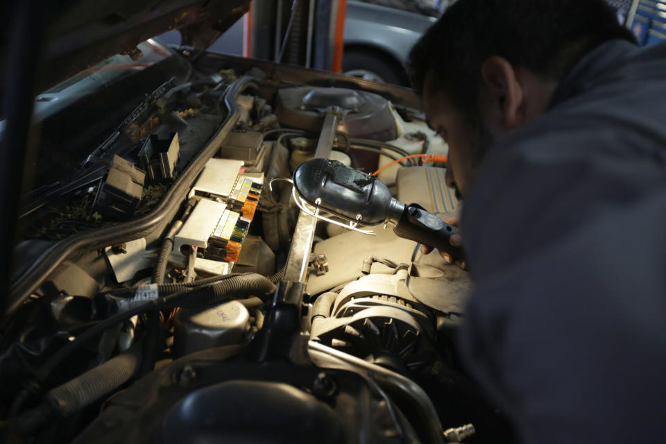 Mechanic Chris Geropoulos works on car, Wednesday, July 5, 2017, at Ted's Auto Clinic in Chicago. In looking for a mechanic, experts say it's a good idea to establish a relationship and find a repair shop you can trust, or you may risk big problems. Good old word-of-mouth still is probably the best way to pick a garage, says George Geropoulos, service adviser at Ted's Auto Clinic in northwest Chicago. (AP Photo/G-Jun Yam)