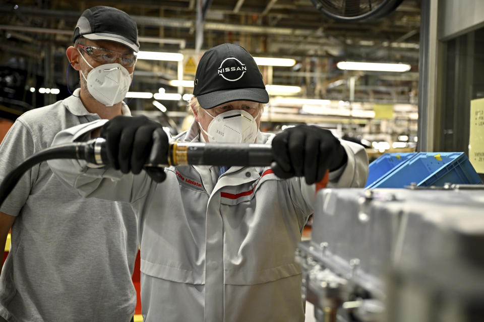 British Prime Minister Boris Johnson visits the Nissan Motor Co. plant, in Sunderland, England, Thursday, July 1, 2021. Japanese carmaker Nissan and two partners announced plans to invest 1 billion ($1.4 billion) pounds to produce a new model of an all-electric vehicle and batteries in northeast England, a major victory for the U.K. government’s efforts to attract jobs and investment following the country’s departure from the European Union. ( Jeff J Mitchell/Pool Photo via AP)