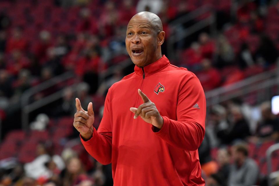 Louisville head coach Kenny Payne sends instructions in to his team during the first half of an NCAA college basketball game against Miami in Louisville, Ky., Sunday, Dec. 4, 2022. (AP Photo/Timothy D. Easley)