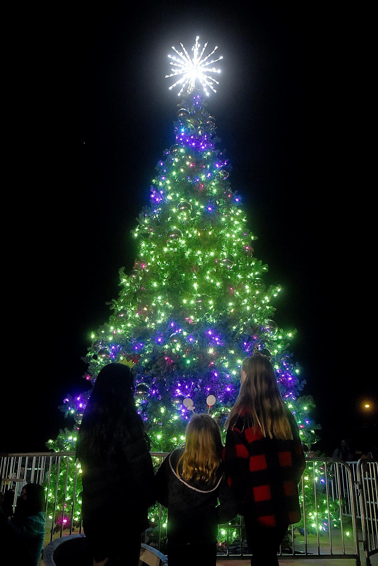 Kids watch as the Christmas tree is lit during Shelter Insurance’s 56th annual tree-lighting ceremony at 1817 W. Broadway. The West Middle School band entertained the crowd while waiting for the tree-lighting. This year, the Winter Wonderland Garden of Lights opened following the tree-lighting at Shelter Gardens.