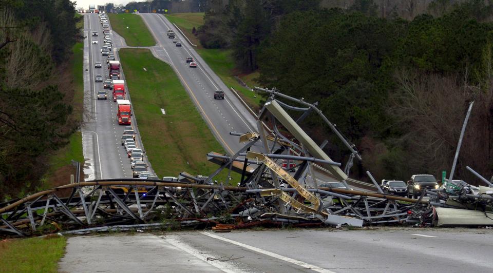 A fallen cell tower lies across U.S. Route 280 highway in Lee County, Ala., in the Smiths Station community after what appeared to be a tornado struck in the area Sunday, March 3, 2019.