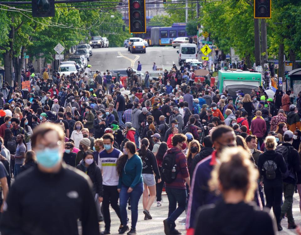 A crowd of people visits the Capitol Hill Autonomous Zone in Seattle, Washington, during protests over the death of George Floyd in Minneapolis.