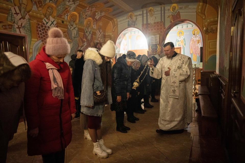 An Orthodox priest blesses believers during Christmas church service in Kostyantynivka, Ukraine (Copyright 2020 The Associated Press. All rights reserved)