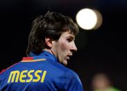 Barcelona's Messi looks on after missing a scoring opportunity against Olympique Lyon during their Champion's League soccer match at the Gerland stadium in Lyon