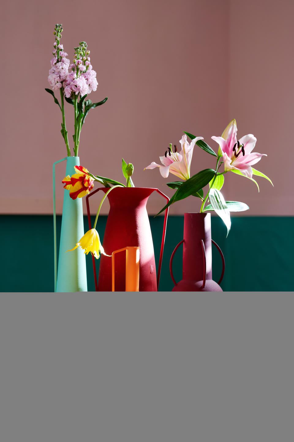 Colorful vases with tulips inside them