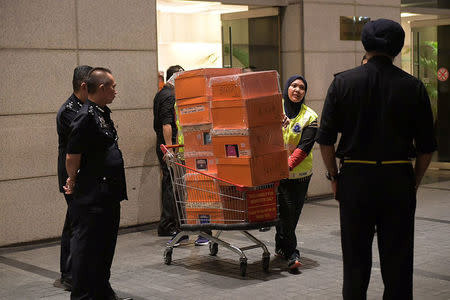 A Malaysian police officer pushes a trolley during a raid of three apartments in a condominum owned by former Malaysian prime minister Najib Razak’s family, in Kuala Lumpur, May 17, 2018, in this photo taken by The Straits Times. Ariffin Jamar/The Straits Times via REUTERS