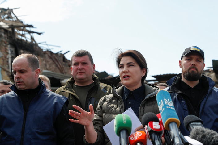 Ukraine Prosecutor General Iryna Venediktova, flanked by several men, speaks at a news briefing.