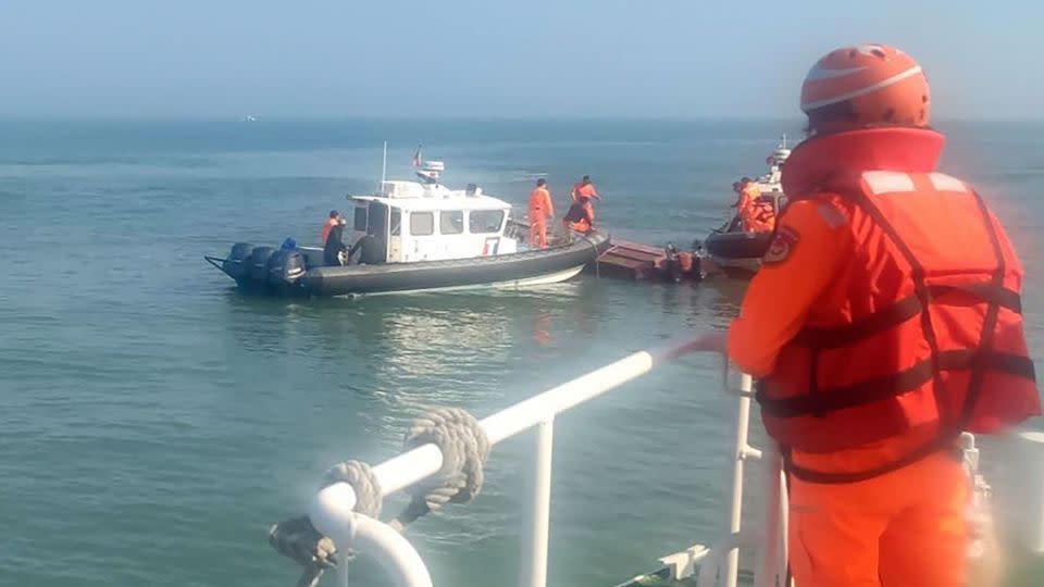 Taiwan's coast guard inspects a vessel that capsized during a chase off the coast of Kinmen on February 14, 2024. - Taiwan Coast Guard Administration/AP