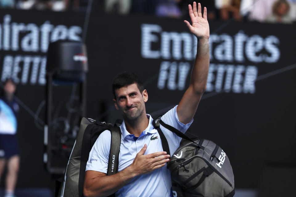 Novak Djokovic of Serbia waves as he leaves Rod Laver Arena after his loss to Jannik Sinner of Italy in their semifinal at the Australian Open tennis championships at Melbourne Park, Melbourne, Australia, Friday, Jan. 26, 2024. (AP Photo/Asanka Brendon Ratnayake)