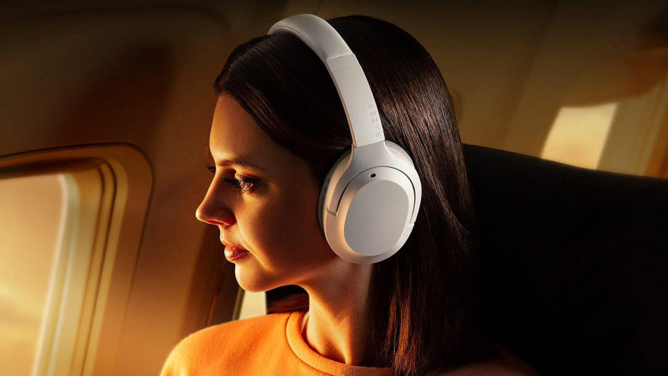 Woman on plane wearing Razer Opus X Wireless.