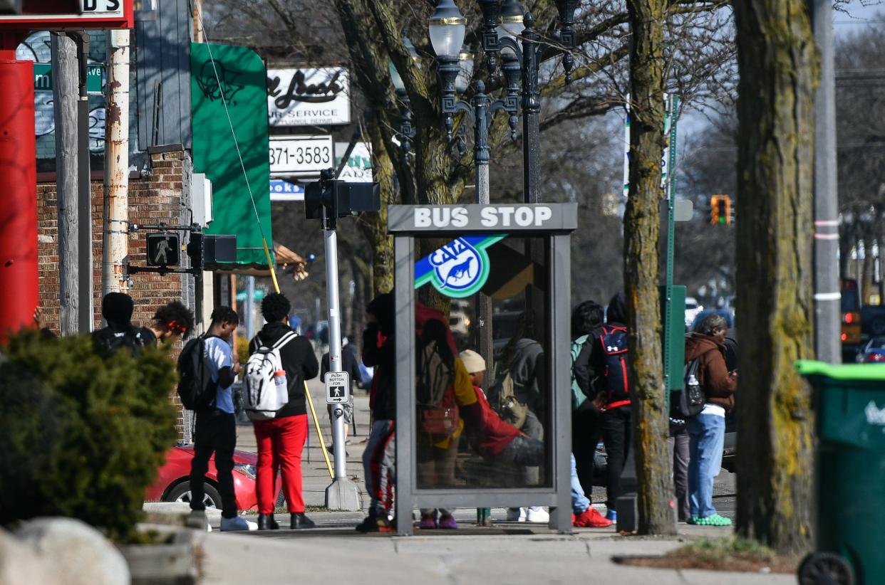 Students from Lansing Eastern High School wait for the CATA bus after school near East Michigan and North Clemens Avenue in Lansing, Tuesday, Feb. 27, 2024.