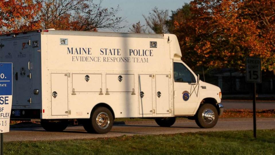 PHOTO: A Maine State Police car drives by an advertisement for a Just-In-Time Recreation bowling alley where the Lewiston mass shooting took place, in Lewinston, Maine, U.S., Oct. 28, 2023. (Shannon Stapleton/Reuters)