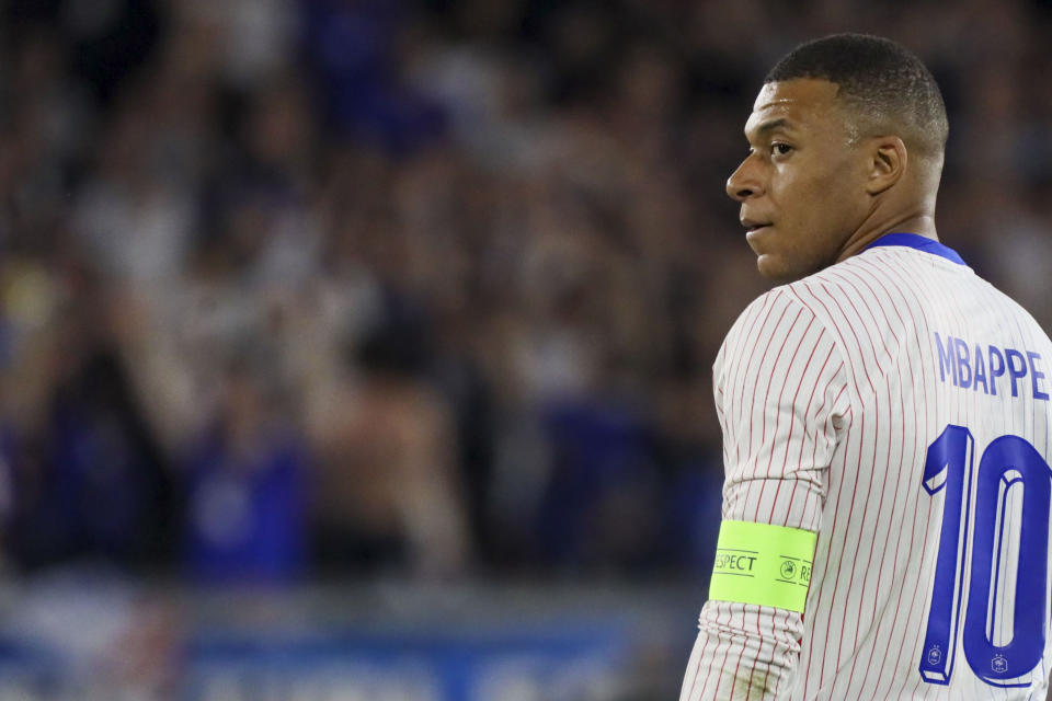 FILE - France's Kylian Mbappe reacts during the international friendly soccer match between France and Canada at the Matmut Atlantique stadium in Bordeaux, southwestern France, Sunday, June 9, 2024. In the end, not even French president Emmanuel Macron could pull enough strings to free up his country's finest soccer player to compete in the Paris Games. (AP Photo/Yohan Bonnet, File)