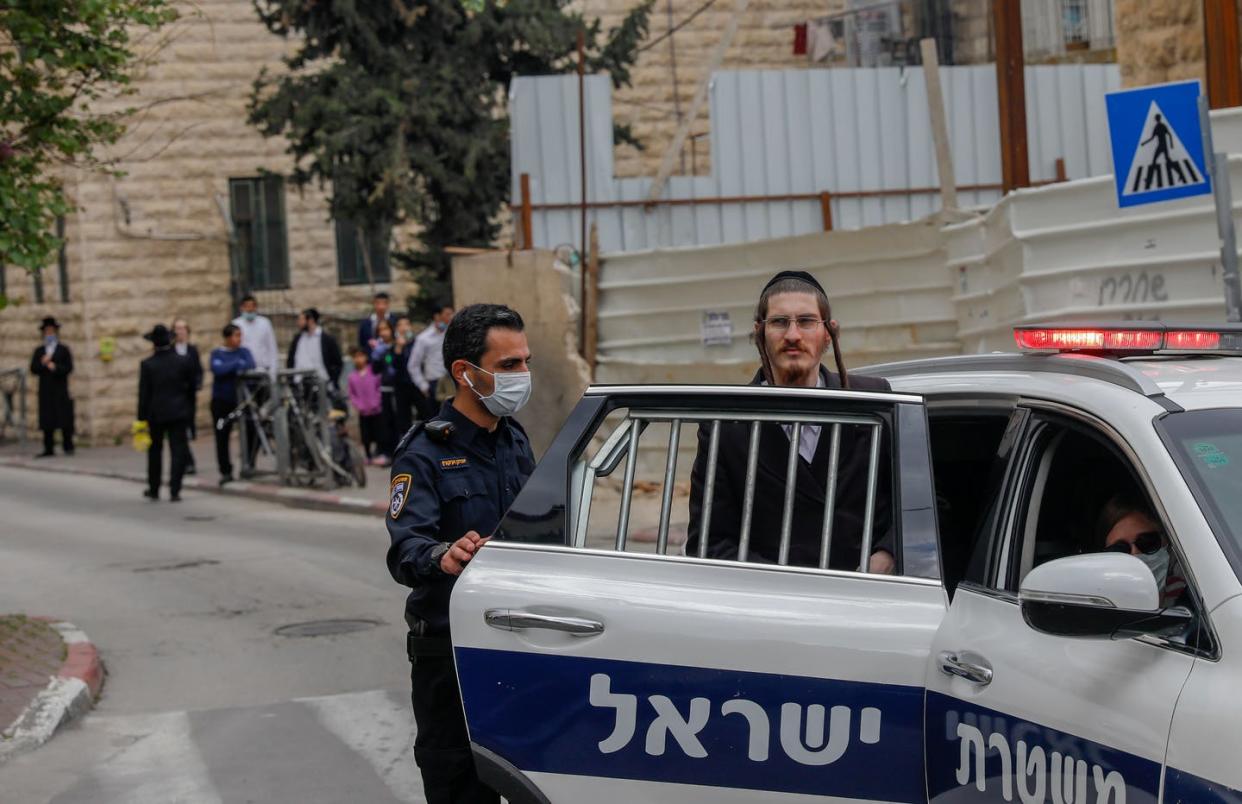 <span class="caption">An Ultra-Orthodox Jewish man is arrested by Israeli security forces for resisting efforts to shut down a synagogue in the Me’a She’arim neighborhood in Jerusalem, April 17, 2020. </span> <span class="attribution"><a class="link " href="https://www.gettyimages.com/detail/news-photo/an-ultra-orthodox-jewish-man-is-arrested-by-israeli-news-photo/1210210788?adppopup=true" rel="nofollow noopener" target="_blank" data-ylk="slk:AHMAD GHARABLI/AFP via Getty Images;elm:context_link;itc:0;sec:content-canvas">AHMAD GHARABLI/AFP via Getty Images</a></span>
