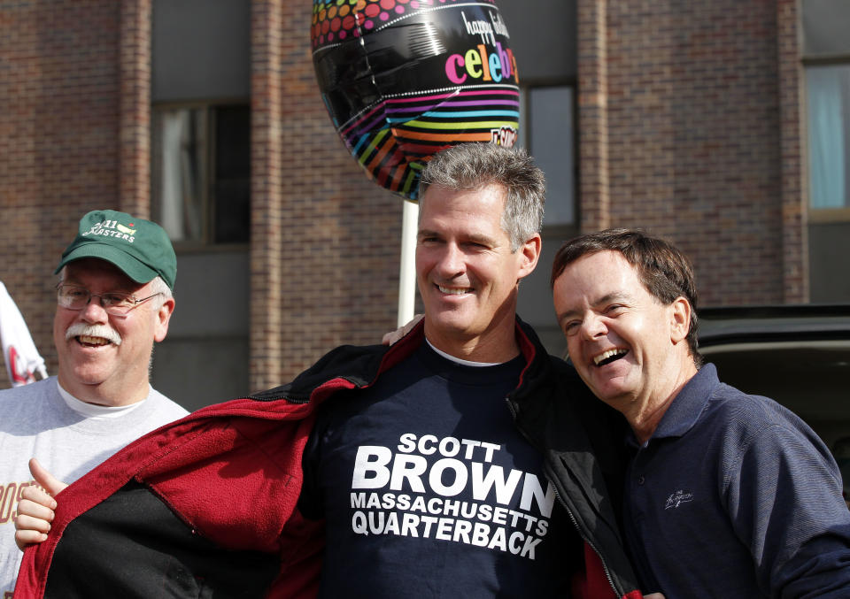 Sen. Scott Brown, R-Mass., center, campaigns with tailgaters outside Alumni Stadium before an NCAA college football game between Boston College and Maryland in Boston, Saturday, Oct. 27, 2012. (AP Photo/Michael Dwyer)