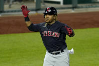 Cleveland Indians' Jose Ramirez celebrates as he runs home after hitting a solo home run during the eighth inning of a baseball game against the Kansas City Royals Wednesday, May 5, 2021, in Kansas City, Mo. (AP Photo/Charlie Riedel)