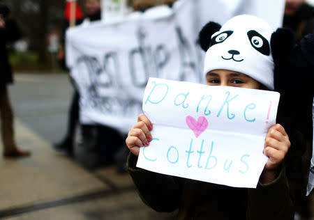 A child holds placard during the demonstration against discrimination of migrants in Cottbus, Germany February 3, 2018. Sign reads "Thank you Cottbus!". REUTERS/Hannibal Hanschke