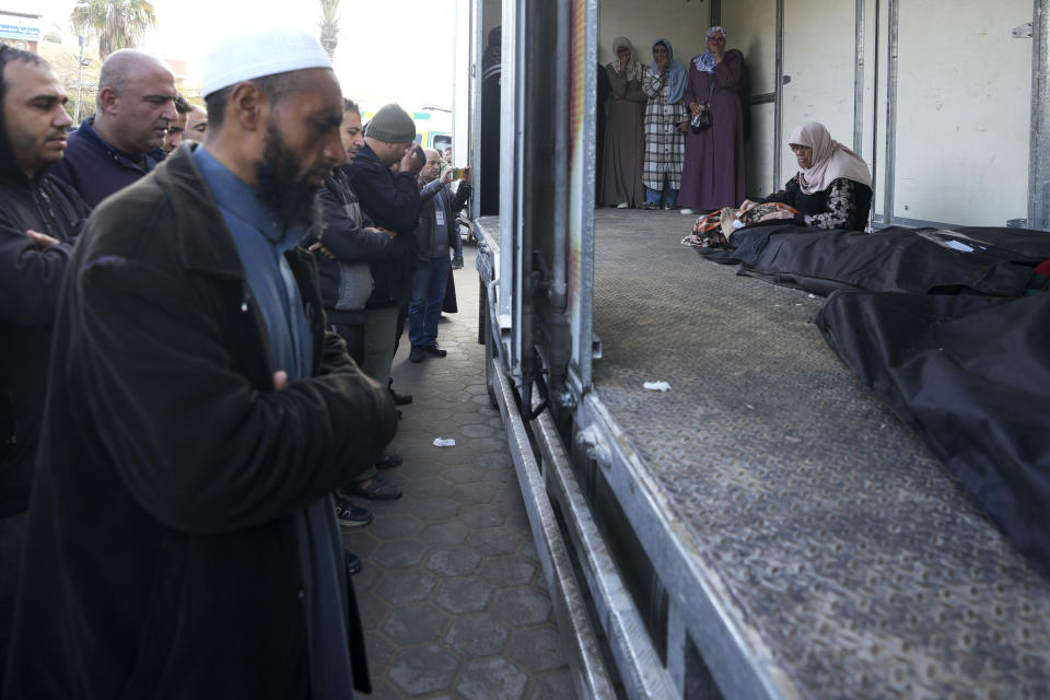 Palestinians morn by the bodies of their relatives killed in the Israeli bombardments of the Gaza Strip in front of the morgue of the Al Aqsa Hospital in Deir al Balah on Saturday, Feb. 24, 2024. (AP Photo/Adel Hana)