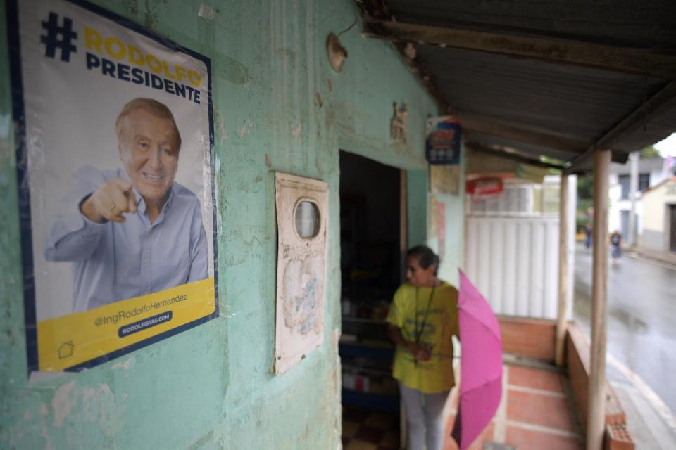 <span class="caption">Presidential candidate Rodolfo Hernandez is seen as the ‘Colombian Trump.’</span> <span class="attribution"><a class="link " href="https://www.gettyimages.com/detail/news-photo/woman-is-seen-near-political-propaganda-of-colombian-news-photo/1241161263?adppopup=true" rel="nofollow noopener" target="_blank" data-ylk="slk:Photo by Raul Arboleda/AFP via Getty Images;elm:context_link;itc:0;sec:content-canvas">Photo by Raul Arboleda/AFP via Getty Images</a></span>