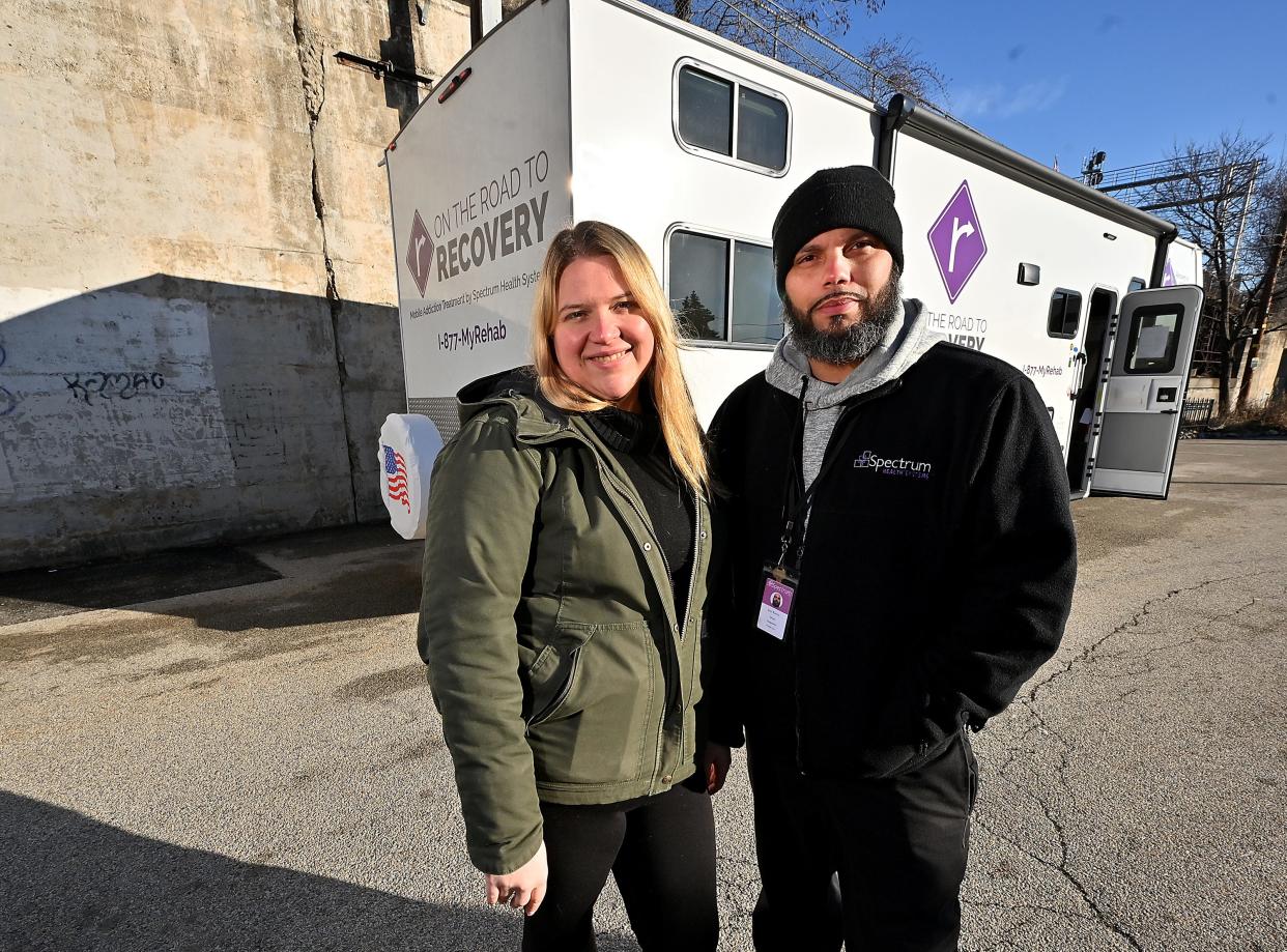 Amanda Bouchard, Spectrum’s director of nursing, and Carlos Ramos, driver and guard, stand before the Road to Recovery van. Spectrum Health Systems announced its mobile treatment service program, the first in the state to provide all three medications for opioid use disorder (MOUD) — methadone, suboxone and vivitrol.