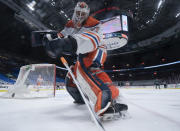 Edmonton Oilers goaltender Mike Smith plays the puck during the first period of an NHL hockey game against the Vancouver Canucks on Thursday, Feb. 25, 2021, in Vancouver, British Columbia. (Jonathan Hayward/The Canadian Press via AP)