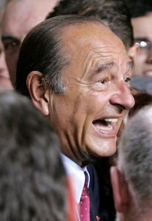 FILE PHOTO: French President Jacques Chirac jokes with supporters in Tulle
