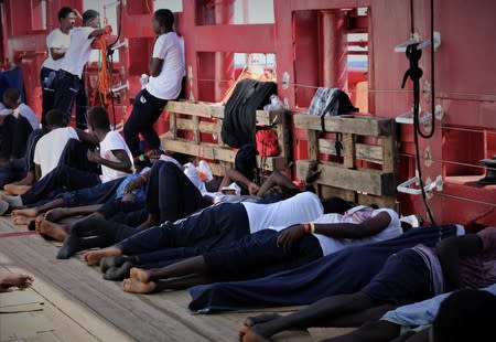 Rescued migrants rest aboard the Ocean Viking in this handout picture