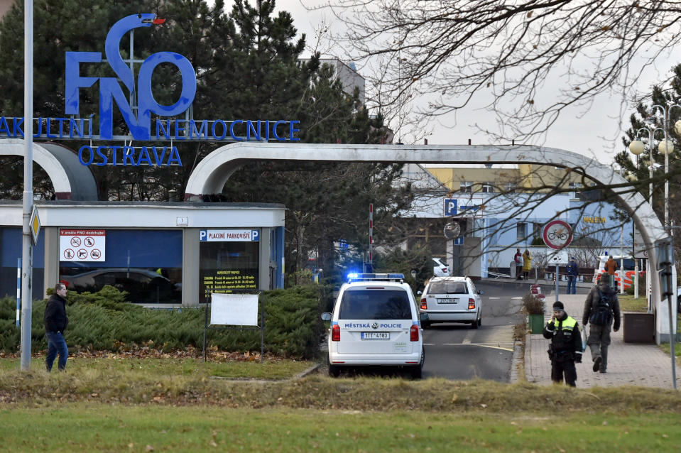 Police car enters an area of the Ostrava Teaching Hospital after a shooting incident in Ostava, Czech Republic, Tuesday, Dec. 10, 2019. Police and officials say at least four people have been killed in a shooting in a hospital in the eastern Czech Republic. Two others are seriously injured. (Jaroslav Ozana/CTK via AP)