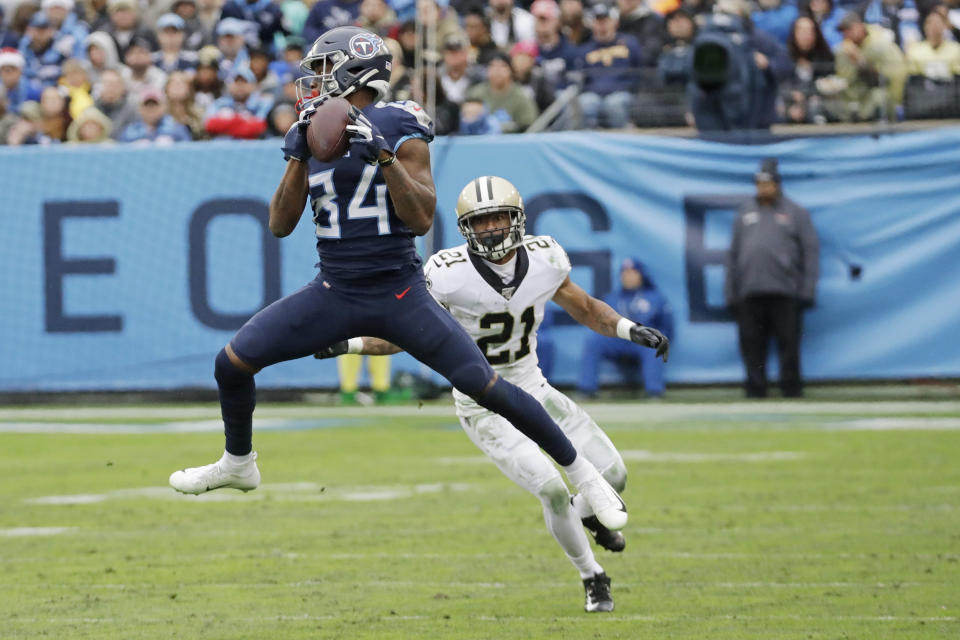 Tennessee Titans wide receiver Corey Davis (84) catches a pass in front of New Orleans Saints defensive back Patrick Robinson (21) in the second half of an NFL football game Sunday, Dec. 22, 2019, in Nashville, Tenn. (AP Photo/James Kenney)