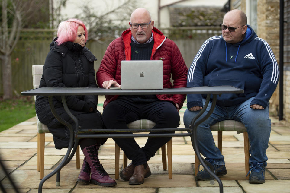 Family advisor Radd Seiger, center, sits with Charlotte Charles and Tim Dunn, parents 19-year-old Harry Dunn, at their home in Charlton, England, Tuesday Nov. 24, 2020. The parents of the British teen Harry Dunn who was killed in a car crash lost a court battle with the U.K. government Tuesday over whether their son’s alleged killer, an American woman, had diplomatic immunity. (Jacob King/PA via AP)