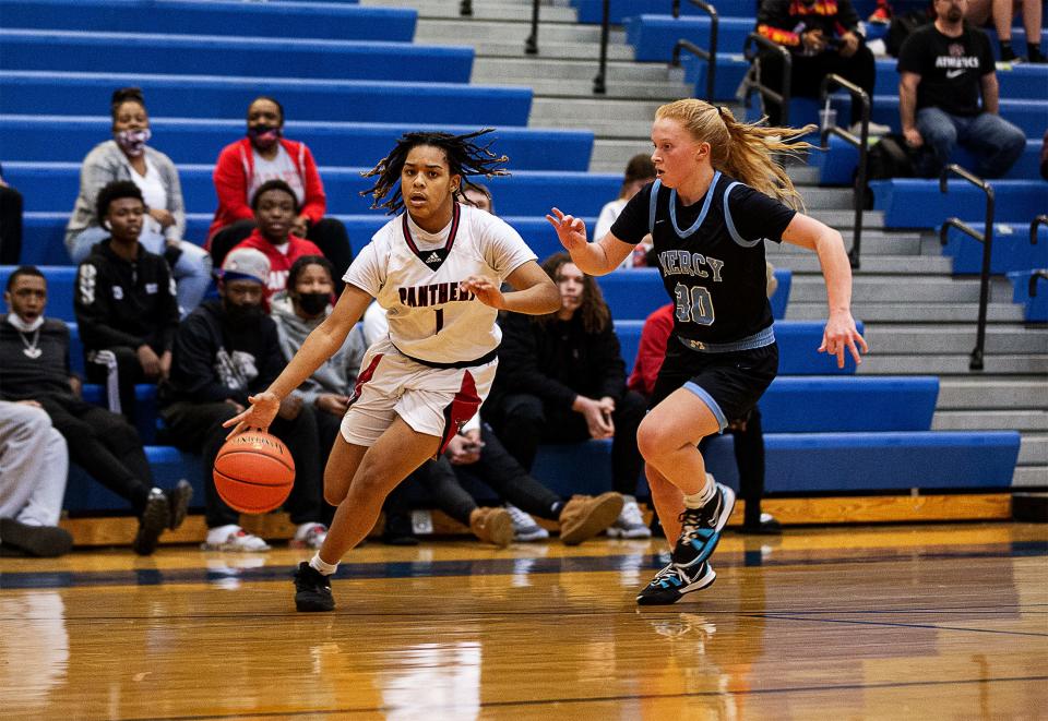 PRP's Tateonah Crawford (1) drove while being defended by Mercy's Gracie Helm (30) during the 6th Region Girls semifinal at Valley High School. The Mercy Jaguars defeated the PRP Panthers, 75-44. March 3, 2022