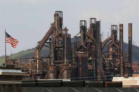 A U.S. flag flies in front of the blast furnaces at the now-closed Bethlehem Steel mill in Bethlehem, Pennsylvania, U.S. April 22, 2016. REUTERS/Brian Snyder